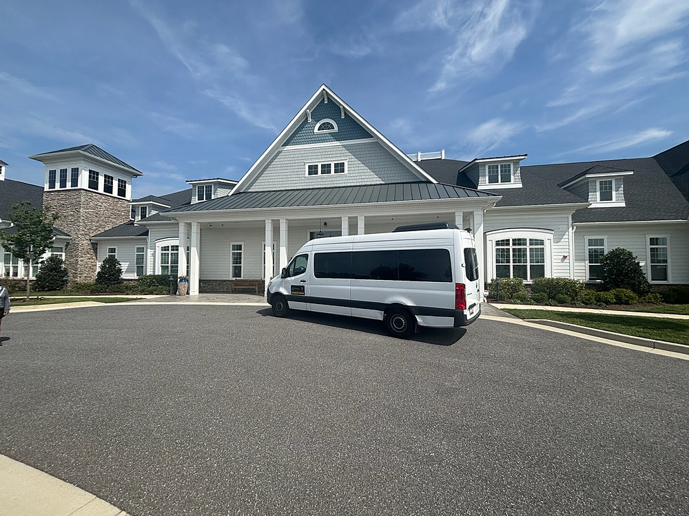 The Top Hat Transportation Mercedes-Benz Sprinter van waiting at a clubhouse entrance on Kent Island